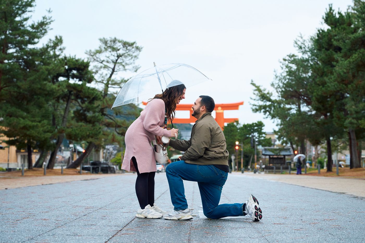 Laughing through the proposal beneath the torii gate